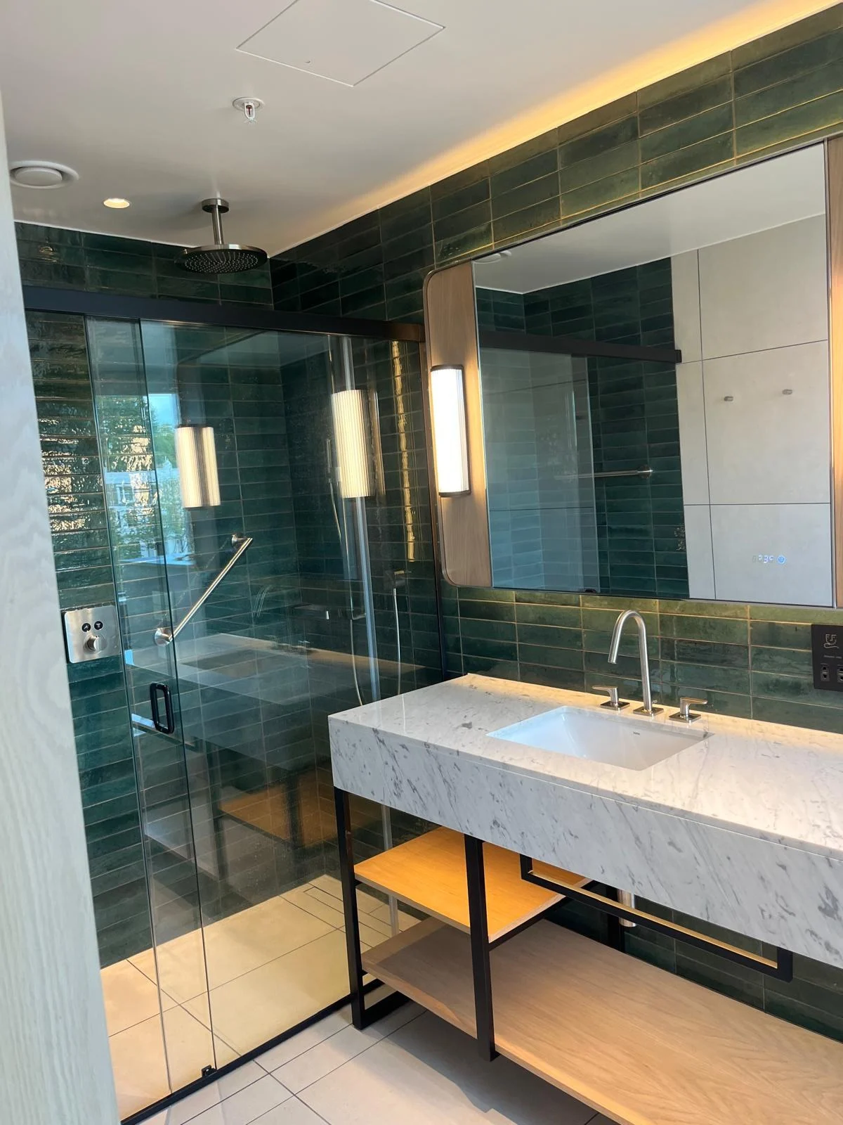 The Hyatt Regency Hotel — Bathroom with green tiles and marble vanity