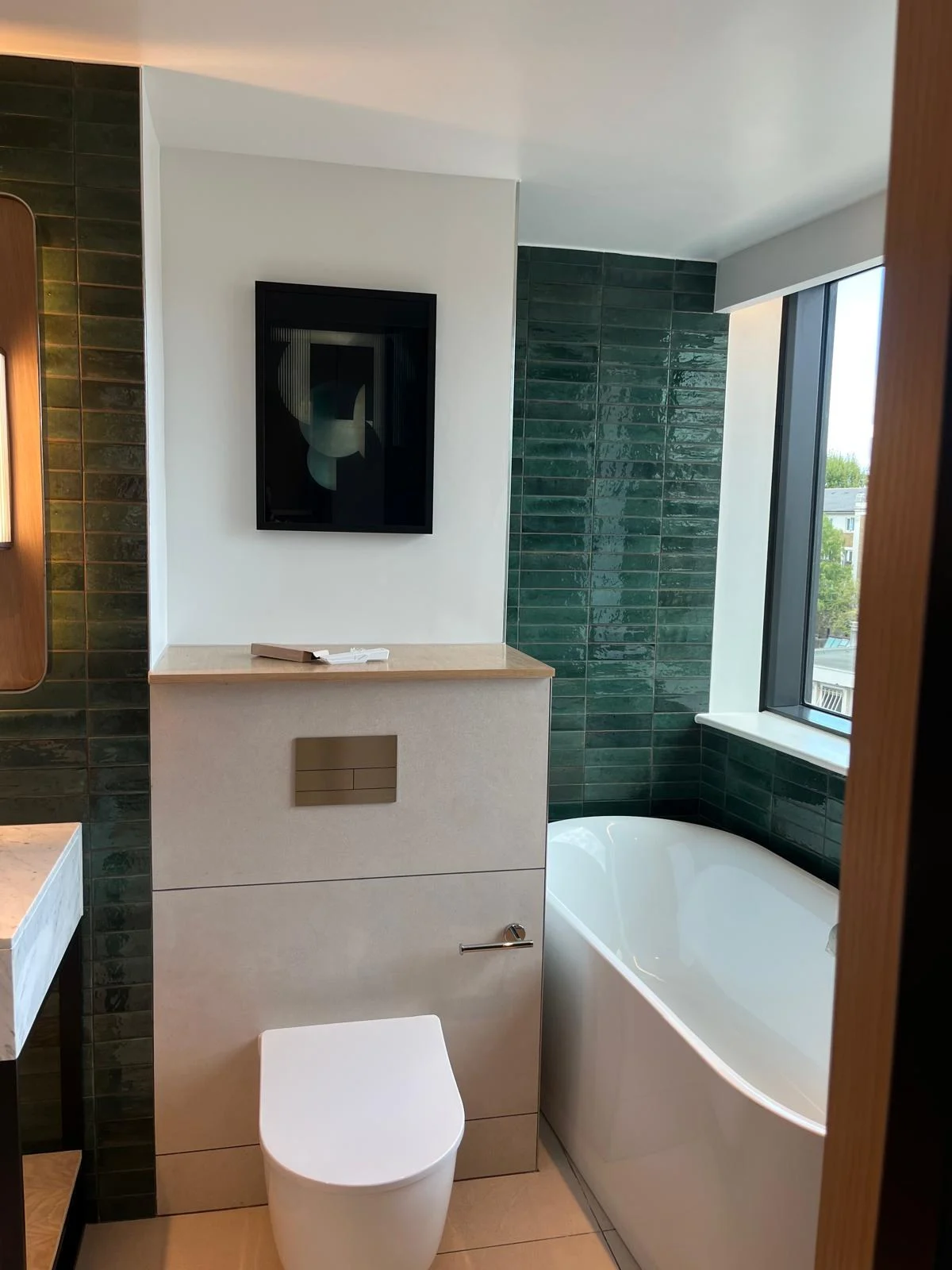 The Hyatt Regency Hotel — Bathroom with bath and green tiled walls